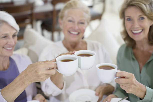 istock Senior women toasting coffee cups 184312796