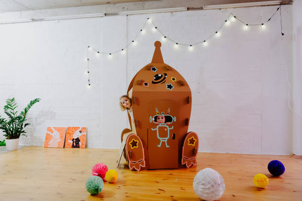 istock Joyful girl playing in cardboard rocket 1843128122
