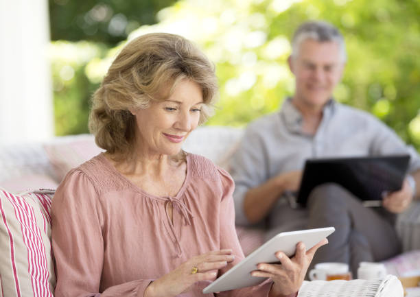 istock Senior woman using digital tablet on patio 184312818