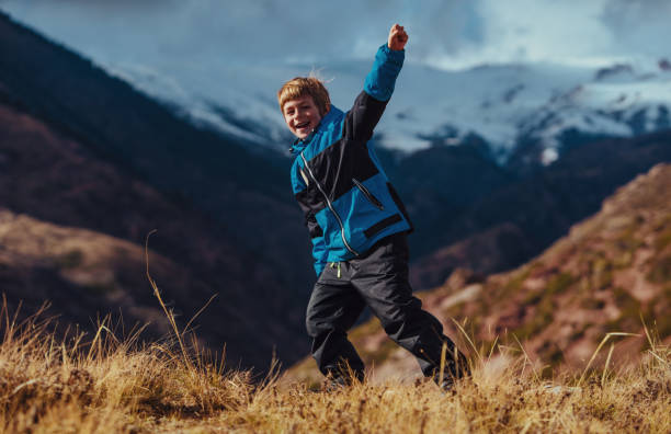 istock Happy successful boy on mountains background in autumn 1843128633