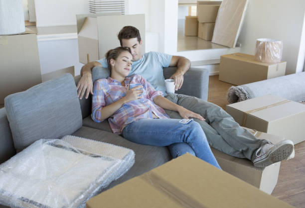istock Couple relaxing on sofa in new house 184313202