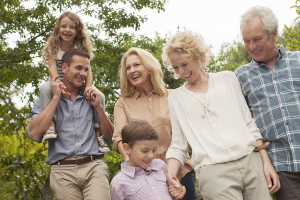 istock Multi-generation family walking together outdoors 184313210