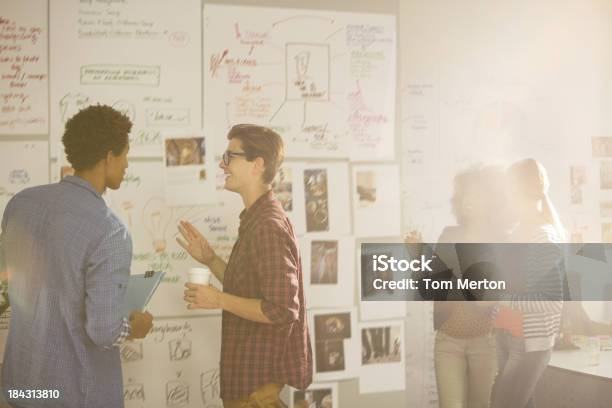 Business People Looking At Flow Charts In Meeting Stock Photo - Download Image Now - Flow Chart, Business, Wall - Building Feature