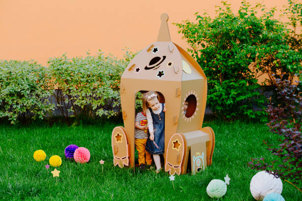 istock Children are having fun at cardboard rocket. 1843138956