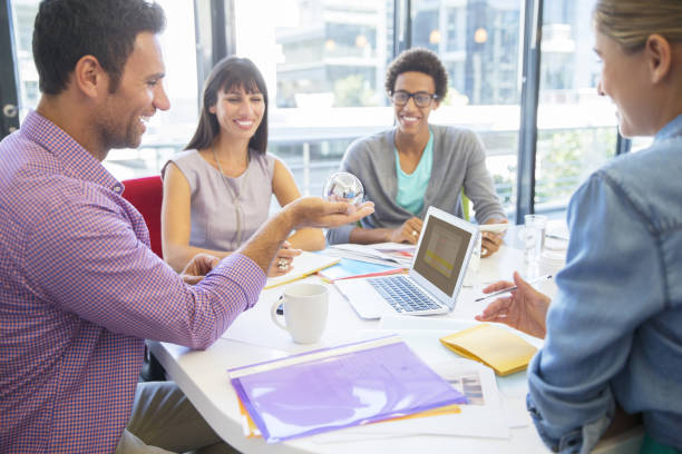 istock Business people examining ball in office 184314147