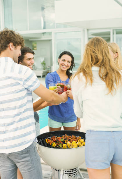 istock Friends toasting cocktails at barbecue 184314413
