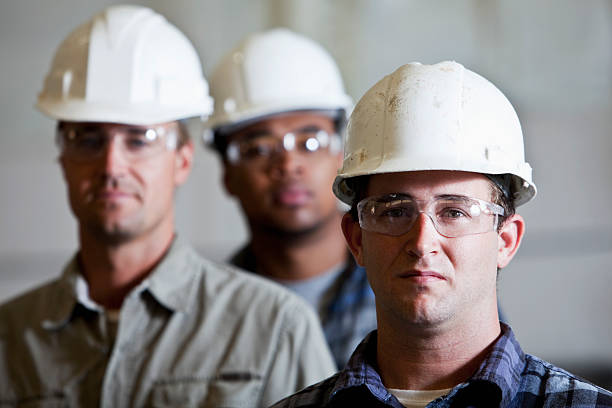 istock Workmen in hardhats and safety glasses 184314480