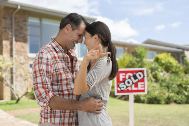 istock Couple hugging outside new house 184314604