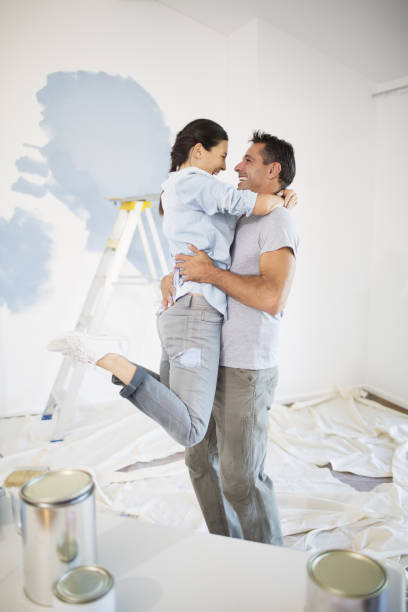 istock Couple hugging among paint supplies 184314615