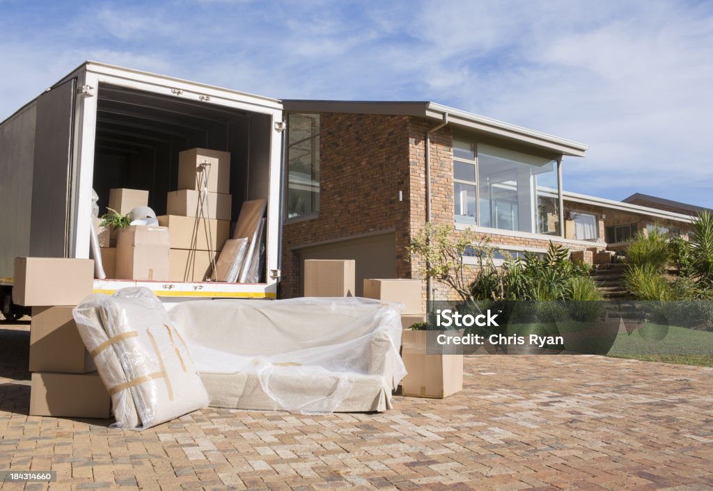 Moving van outside house  Moving Van Stock Photo