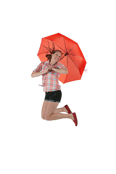 istock Woman jumping with umbrella 184314736