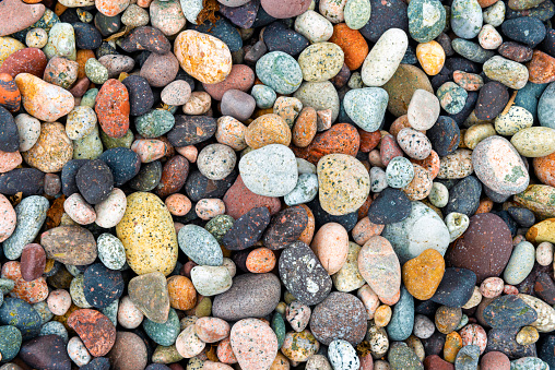 colorful pebbles on a beach in Porto, Corsica, France