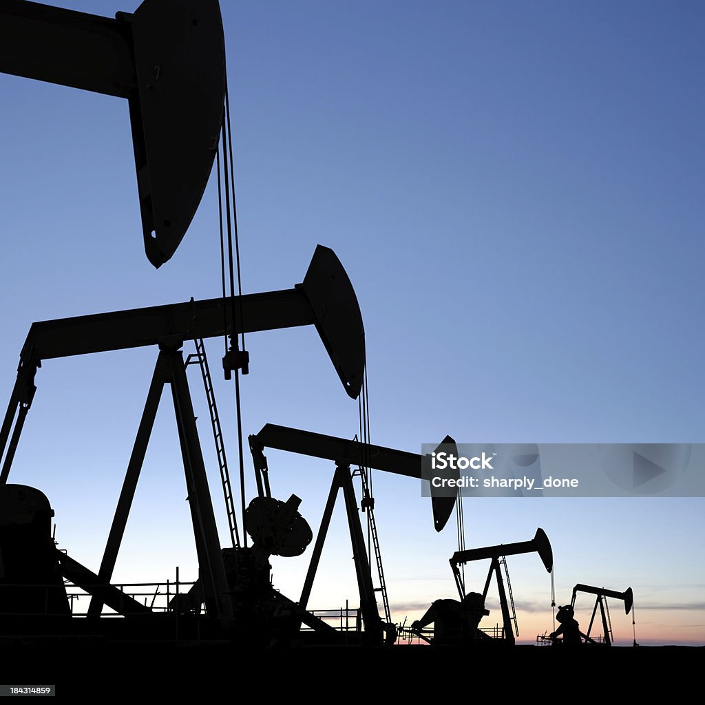 XXXL oil pumpjack silhouettes "oil pumpjacks in silhouette at twilight, square frame (XXXL)" North Dakota Stock Photo