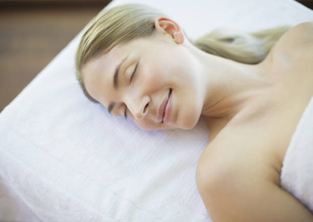 adult woman lying on table waiting to start beauty treatment