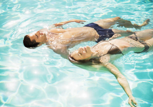 istock Couple floating in swimming pool 184314992