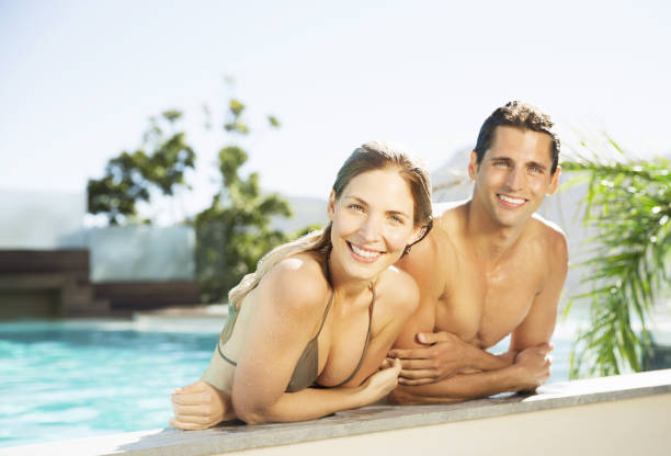 istock Couple relaxing in swimming pool 184315135