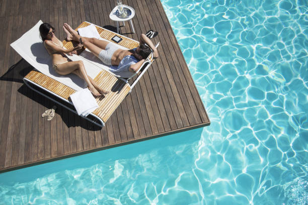 Summer concept, straw hat with sunnies by the pool