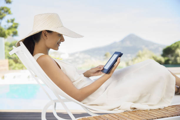 Young woman relaxing on sunbed on the beach