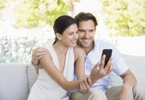 istock Couple taking self-portrait with camera phone 184315492