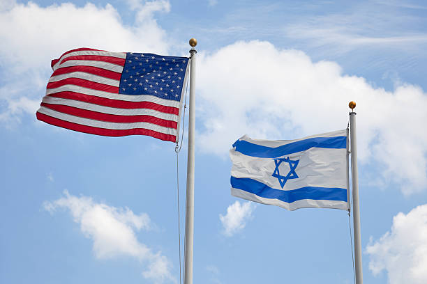 USA & Israeli Flags United States & Israeli flags wave together in unison symbolizing concepts such as the American/Israeli bond and Judaism in America. Here are some related images: israeli flag photos stock pictures, royalty-free photos & images