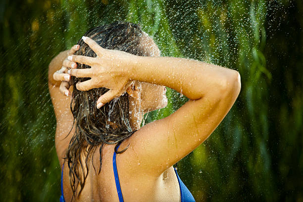 istock Young Woman Under An Outside Shower 184316073