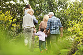 Multi-generation family walking in park