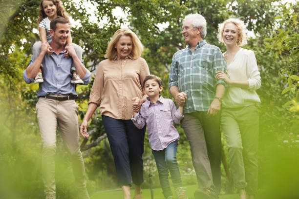 istock Multi-generation family walking in park 184316097