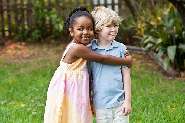 istock Little girl hugging boy 184316515