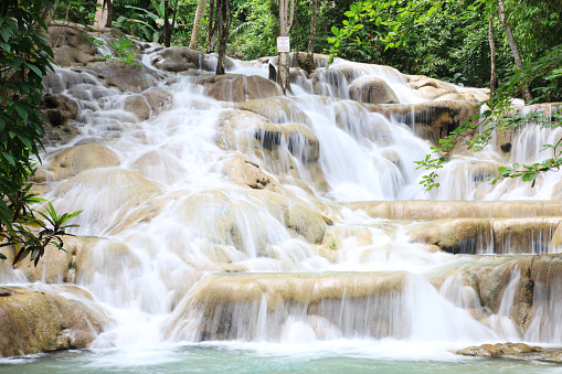 Dunn's River Falls is a 600 feet (180 m) high waterfall near Ocho Rios, Jamaica. It is a major Caribbean tourist destination attracting tourists who climb up the terraced waterfalls.