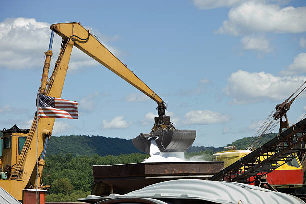 Rear quarter view of a jacked up mobile crane on a construction site.