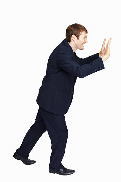 istock Business man trying to push something 184317221