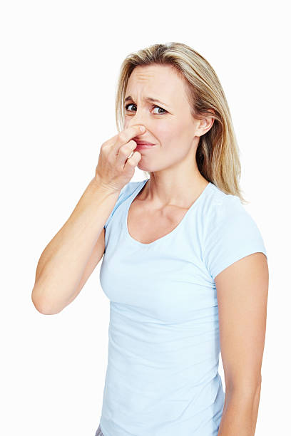 Stinky Portrait of beautiful woman pinching her nose on white background holding nose stock pictures, royalty-free photos & images