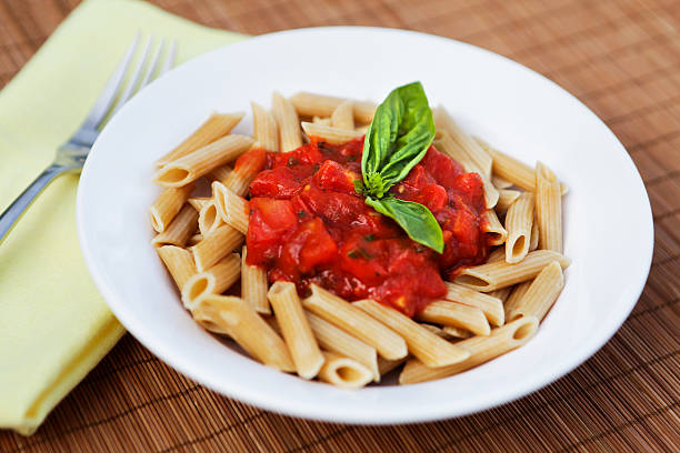 Whole wheat pasta with chunky tomato sauce and fresh basil