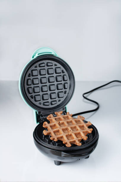 istock Viennese waffle lies in an electric waffle iron, copy space 1843174346