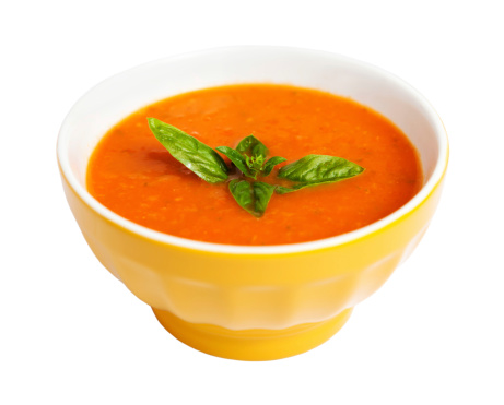Tomato soup isolated on white with a basil garnish. Clipping path included.See similar photos: