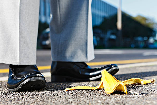 istock Sidestepping a problem: businessman's feet next to banana peel 184317715