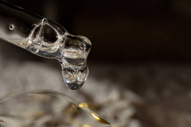 istock A drop of cosmetic aromatic oil drips from the pipette. Front view. 1843178535