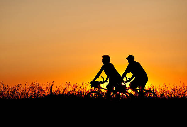 istock Silhouette of Two Cyclists 184318040