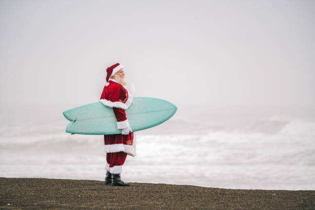istock Santa Claus on the beach with surfboard 1843182166