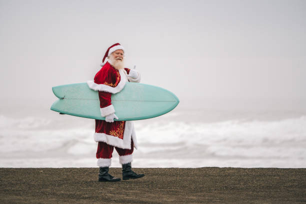 istock Santa Claus on the beach with surfboard 1843182167