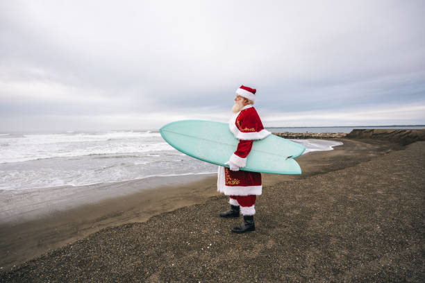 istock Santa Claus on the beach with surfboard 1843182468