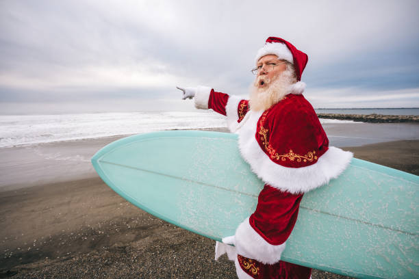 istock Santa Claus on the beach with surfboard 1843182677