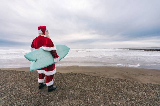 istock Santa Claus on the beach with surfboard 1843182679