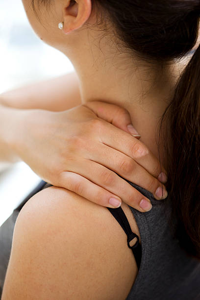 istock Woman Rubbing Her Own Neck and Shoulder 184318275