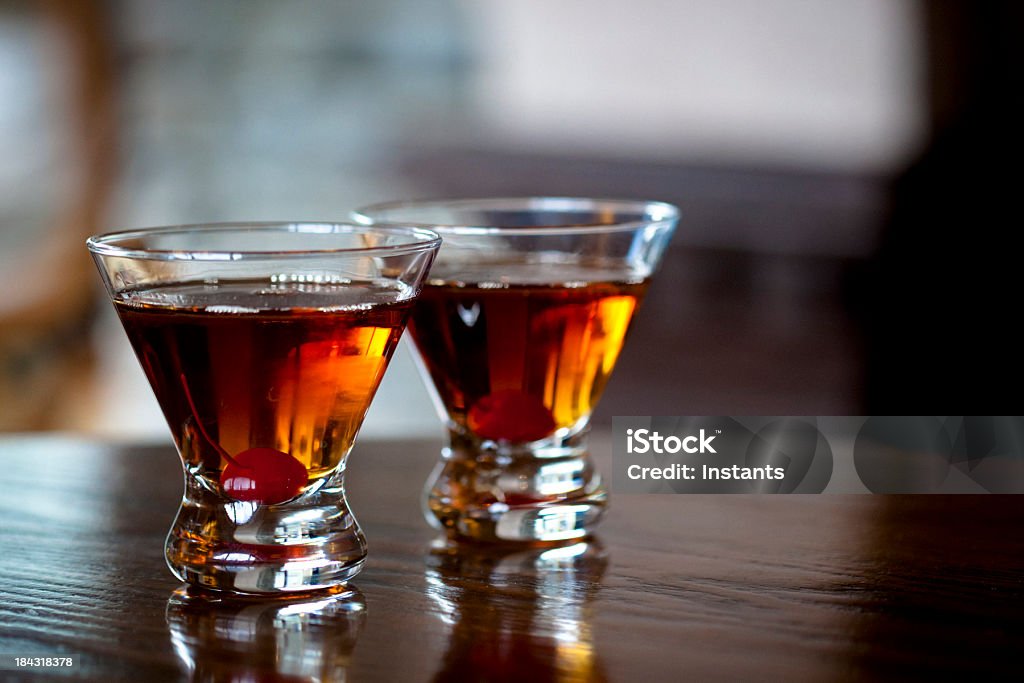 Manhattan cocktails Two Manhattan cocktails on wooden table. Vermouth Stock Photo