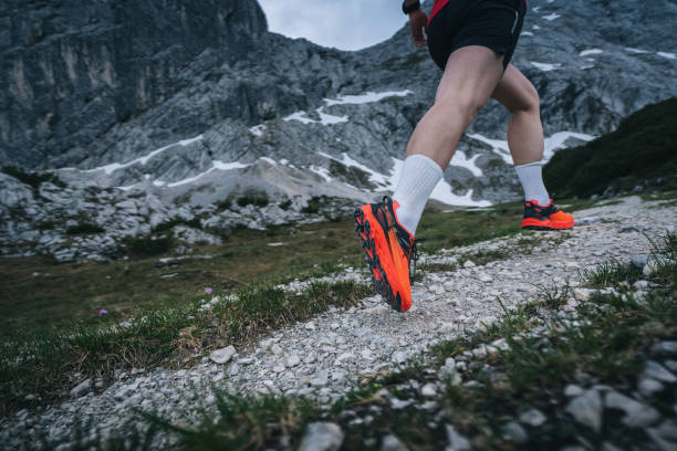 istock Female trail runner bounds up mountain trail 1843186374
