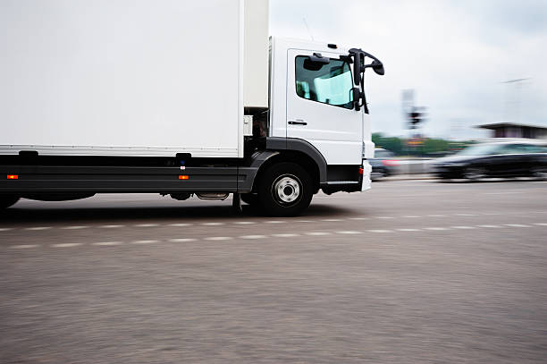 Fast white truck in the city Truck in traffic. Focus on front. Stockholm city center. stockholm town square sergels torg sweden stock pictures, royalty-free photos & images