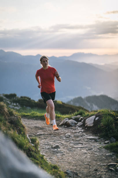 istock Female trail runner bounds along mountain pathway 1843186910