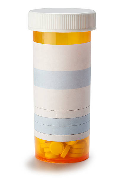 Blank prescription medication bottle on white background. A blank prescription bottle with all text removed. Photographed on a white background in a studio setting. Pills can be seen at the bottom of the bottle. Clipping path included. pill bottle photos stock pictures, royalty-free photos & images