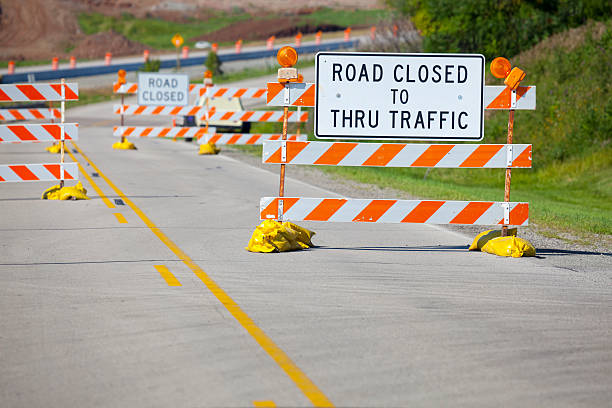 istock Summer Construction and Road Closed Signs Blocking Street 184318998